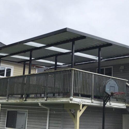 Aluminum patio cover with clear glass and black frame