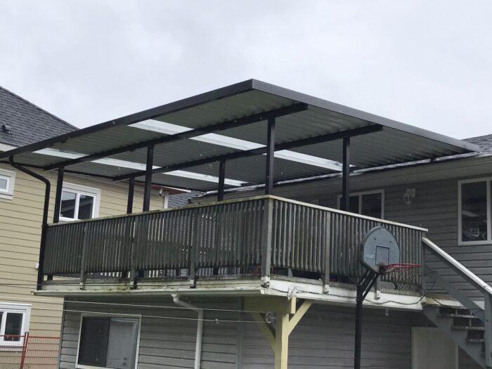 Aluminum patio cover with clear glass and black frame