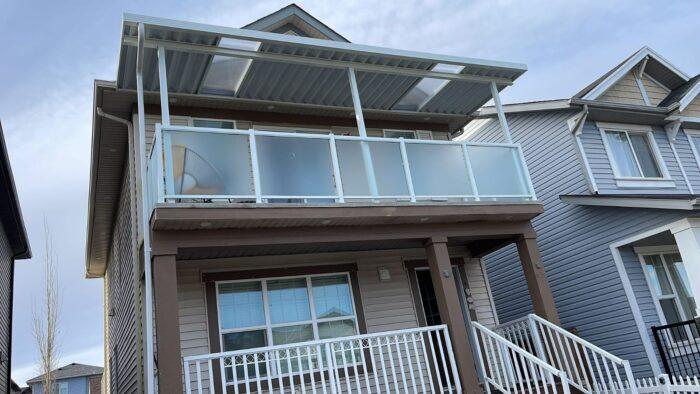 Aluminum patio cover with clear glass and white frame