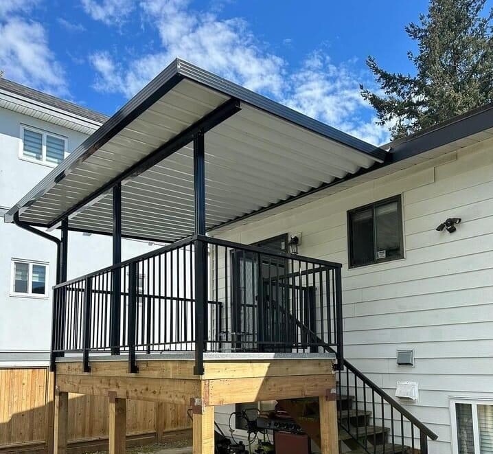 Aluminum patio cover installation Vancouver BC with glass roof and modern railing